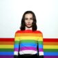 woman with LGBTQ flag accros her body
